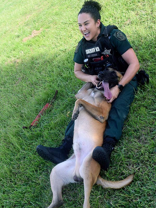 Female officer playing with k-9