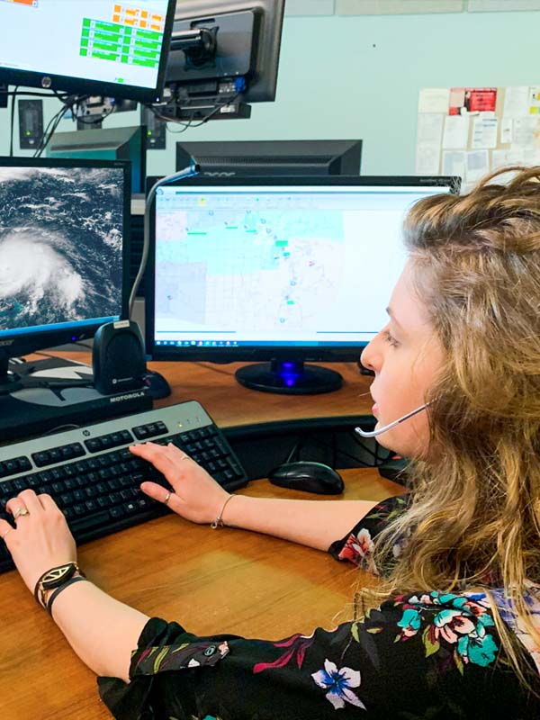 Femail Dispatcher working on computer